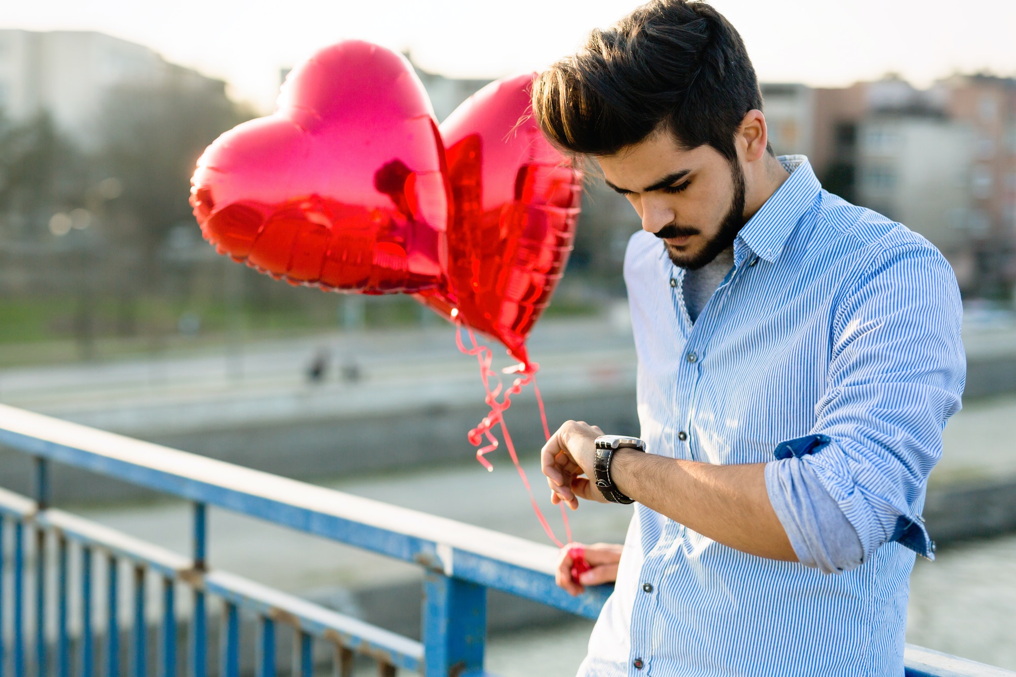 Sad man waiting for date on valentine date